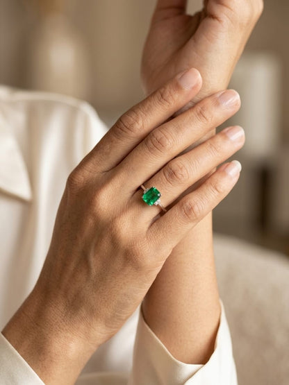Emerald cut emerald ring with diamond accents in 18K white gold