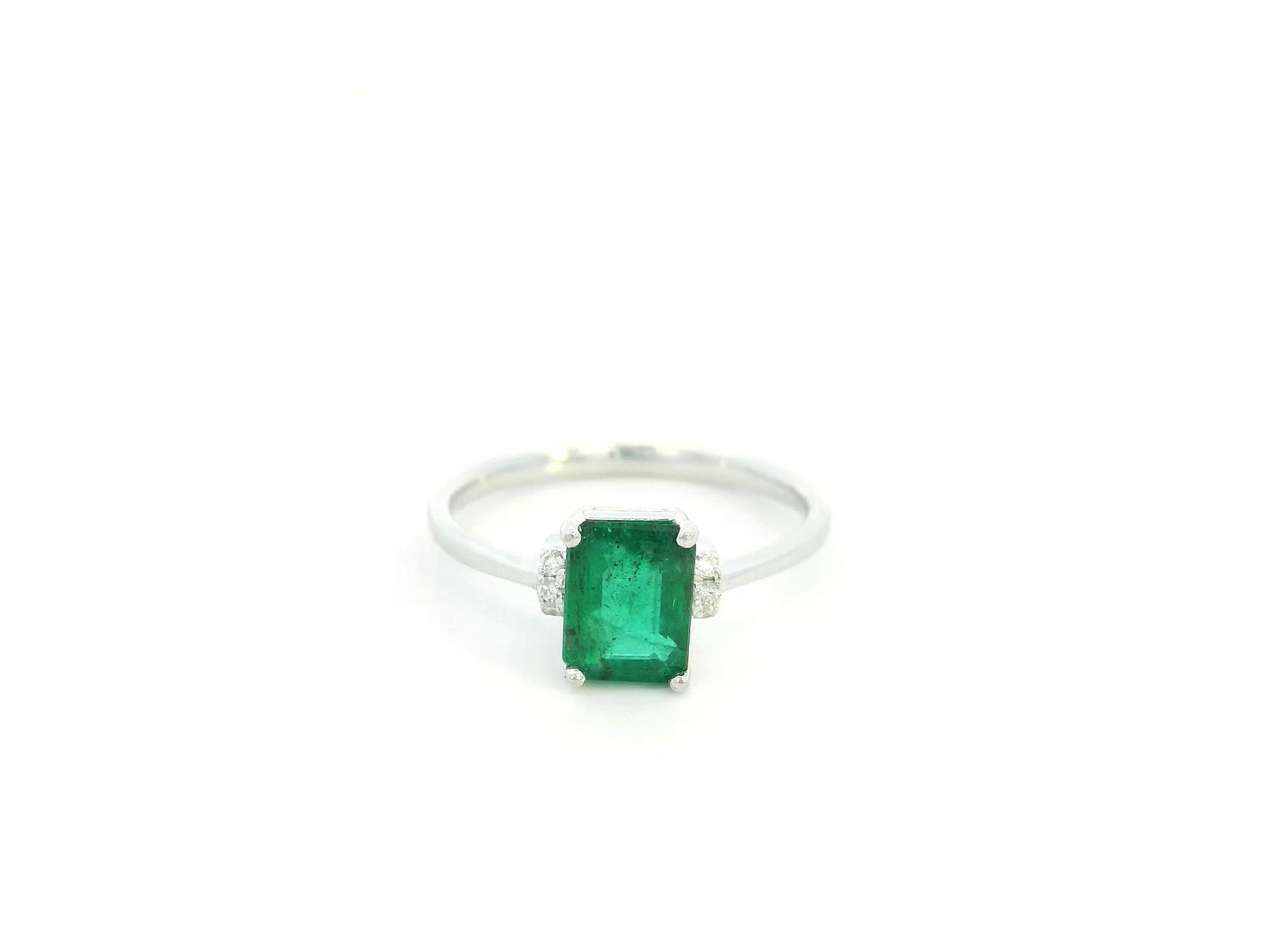 Emerald cut emerald ring with diamond accents in 18K white gold