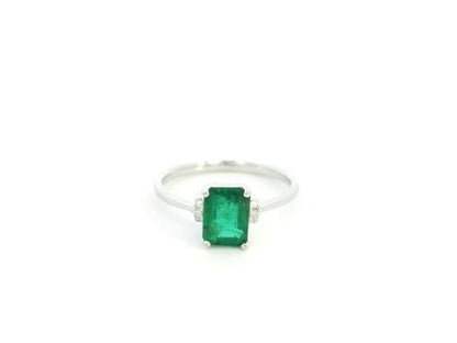 Emerald cut emerald ring with diamond accents in 18K white gold