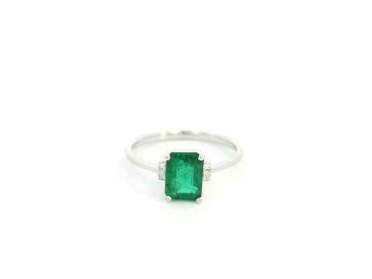 Emerald cut emerald ring with diamond accents in 18K white gold