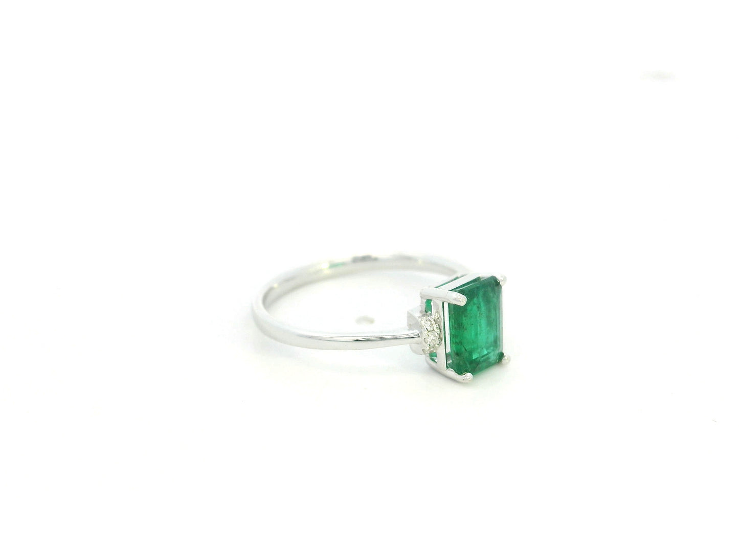 Emerald cut emerald ring with diamond accents in 18K white gold