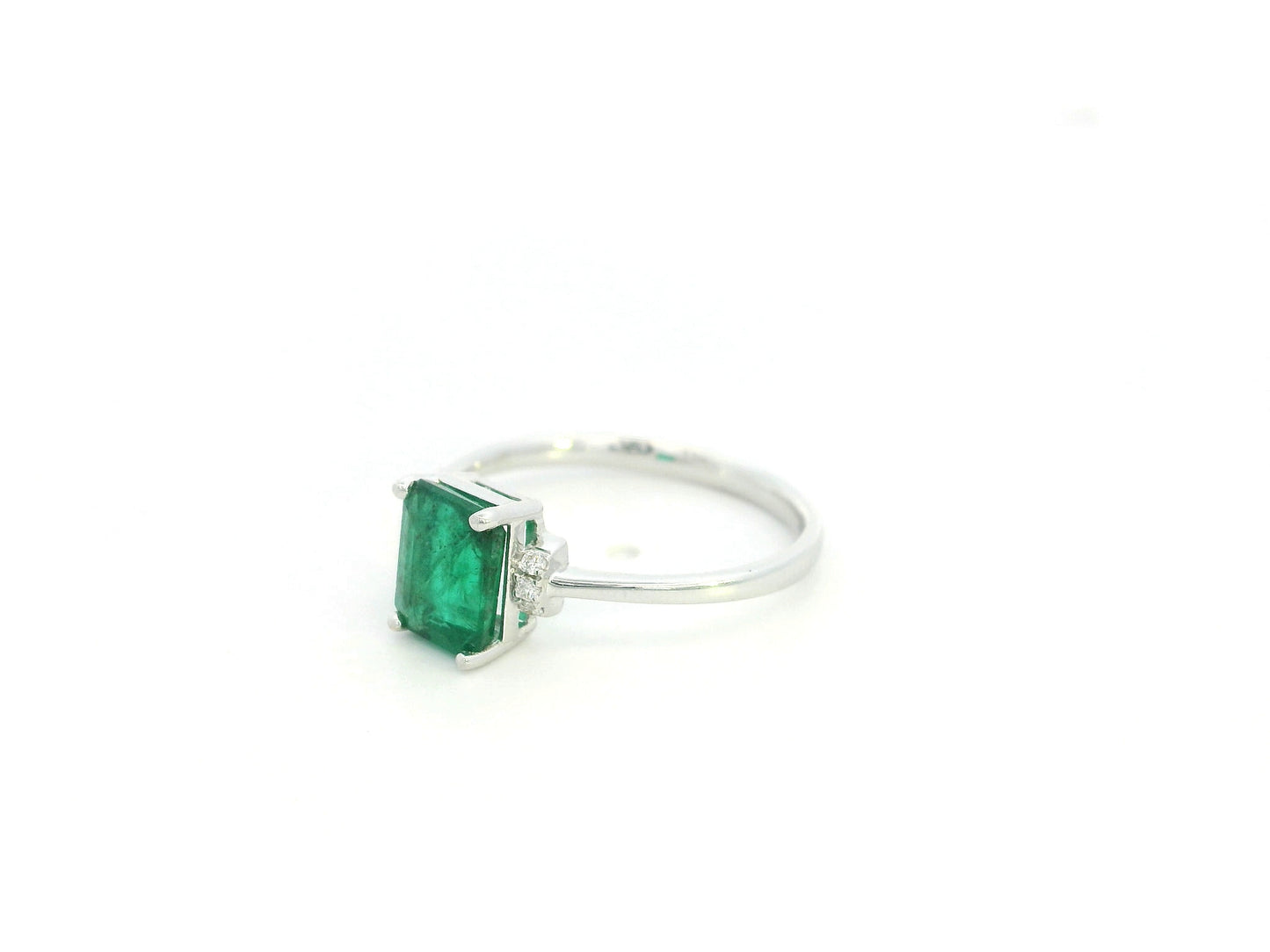 Emerald cut emerald ring with diamond accents in 18K white gold