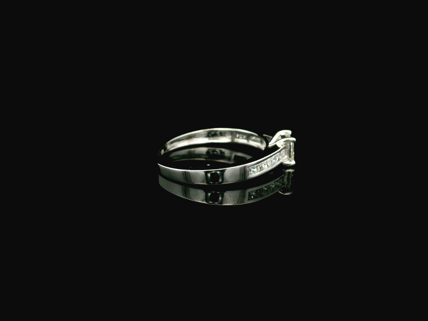 Princess cut diamond engagement ring in 18K white gold with channel set diamonds
