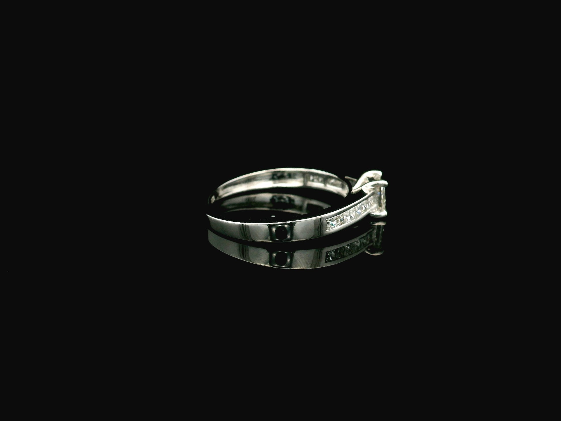 Princess cut diamond engagement ring in 18K white gold with channel set diamonds