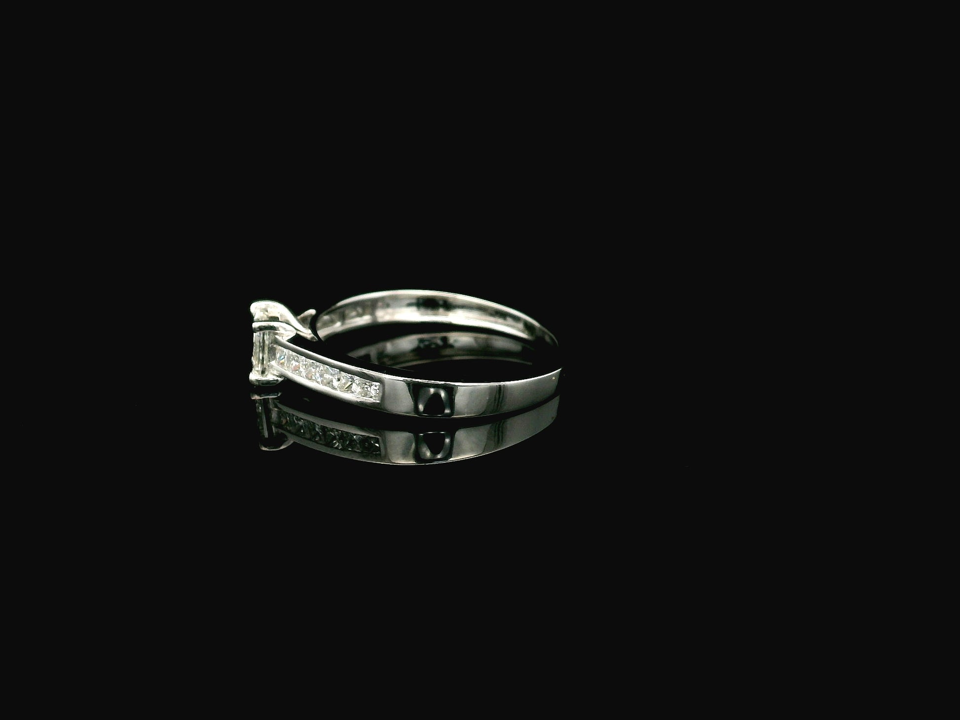 Princess cut diamond engagement ring in 18K white gold with channel set diamonds