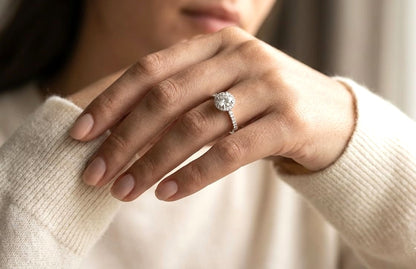 GIA certified round diamond halo engagement ring in 18K white gold with pavé diamond band