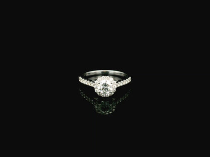 GIA certified round diamond halo engagement ring in 18K white gold with pavé diamond band