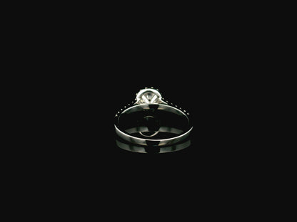 GIA certified round diamond halo engagement ring in 18K white gold with pavé diamond band