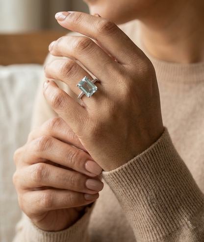 Emerald cut aquamarine ring in 18K white gold with pavé diamond band
