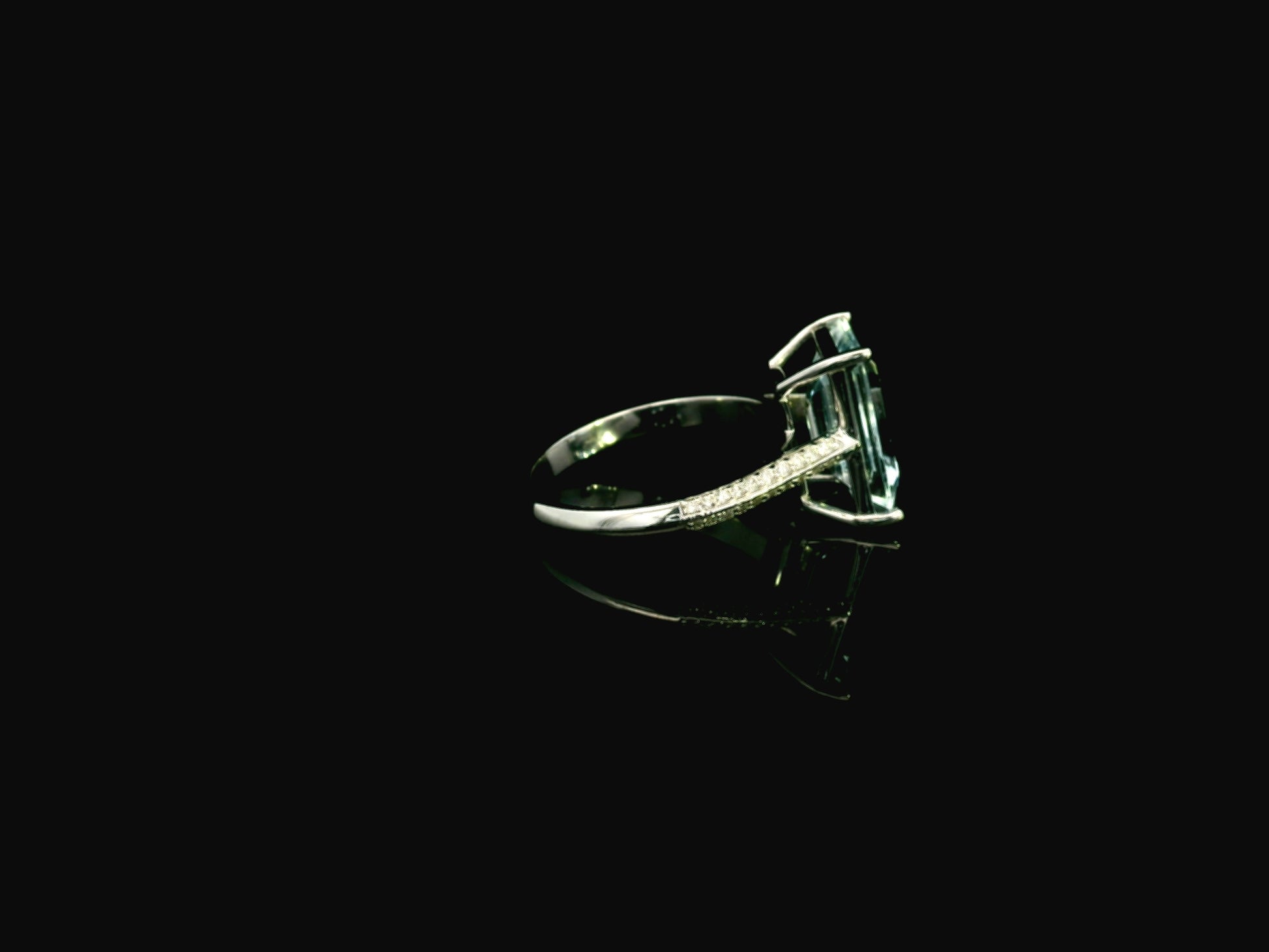Emerald cut aquamarine ring in 18K white gold with pavé diamond band