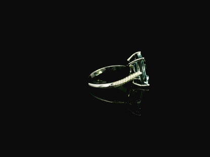 Emerald cut aquamarine ring in 18K white gold with pavé diamond band