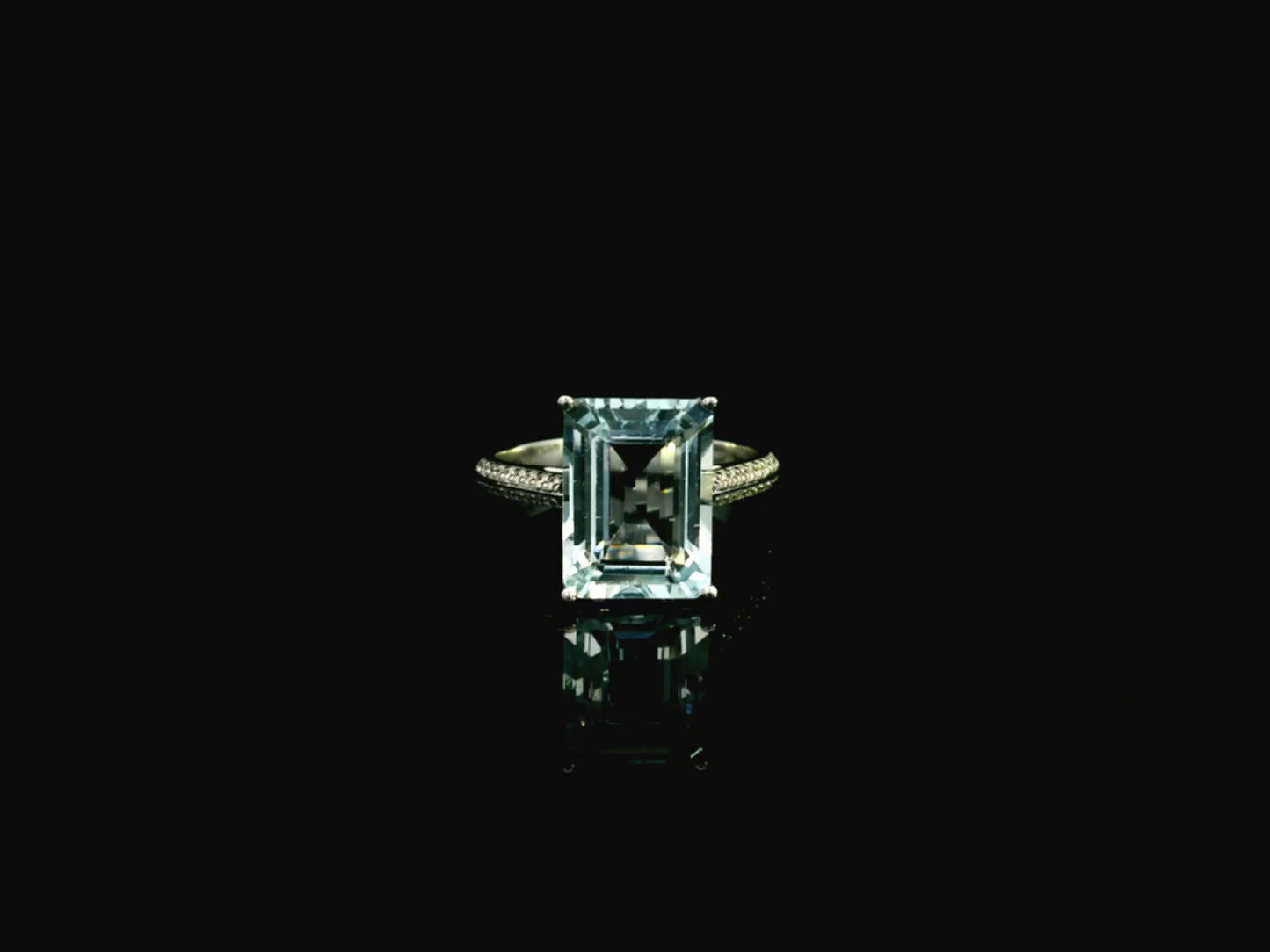 Emerald cut aquamarine ring in 18K white gold with pavé diamond band