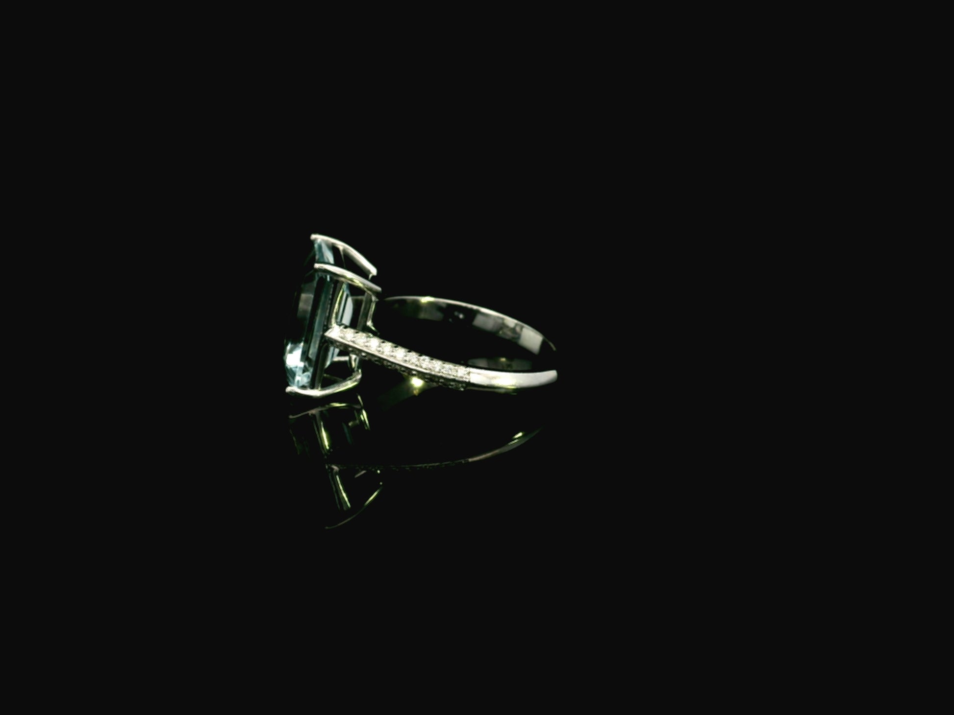 Emerald cut aquamarine ring in 18K white gold with pavé diamond band