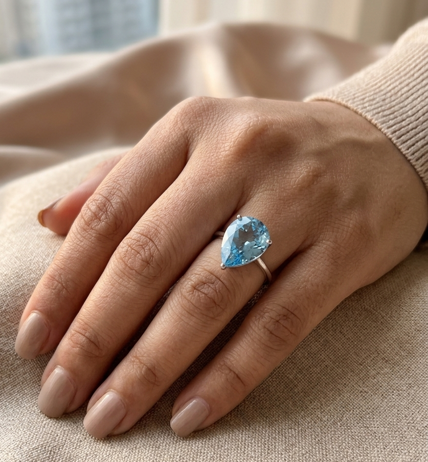 Large pear cut blue topaz solitaire ring in 18K white gold statement design