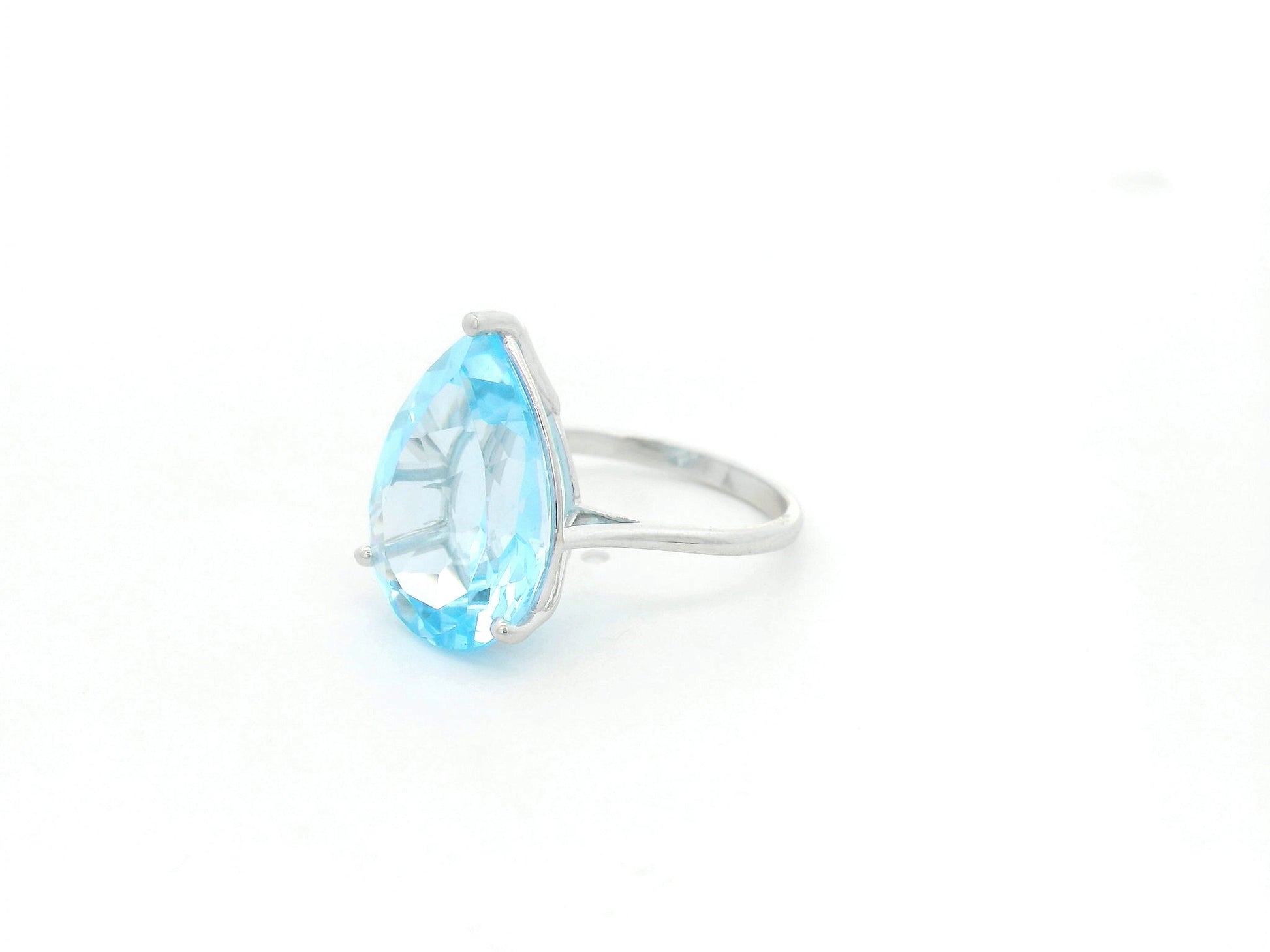 Large pear cut blue topaz solitaire ring in 18K white gold statement design