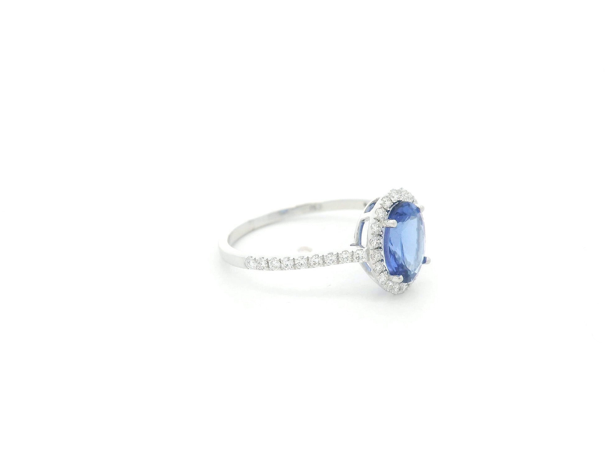 Tanzanite and diamond halo ring in 18K white gold oval gemstone design