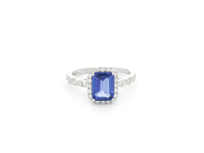 Emerald cut tanzanite halo ring in 18K white gold with marquise diamond band
