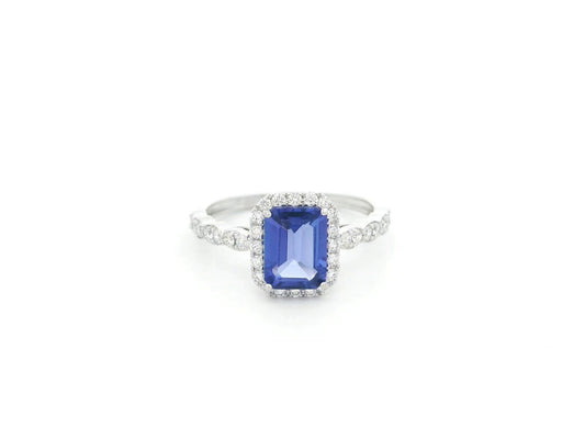 Emerald cut tanzanite halo ring in 18K white gold with marquise diamond band