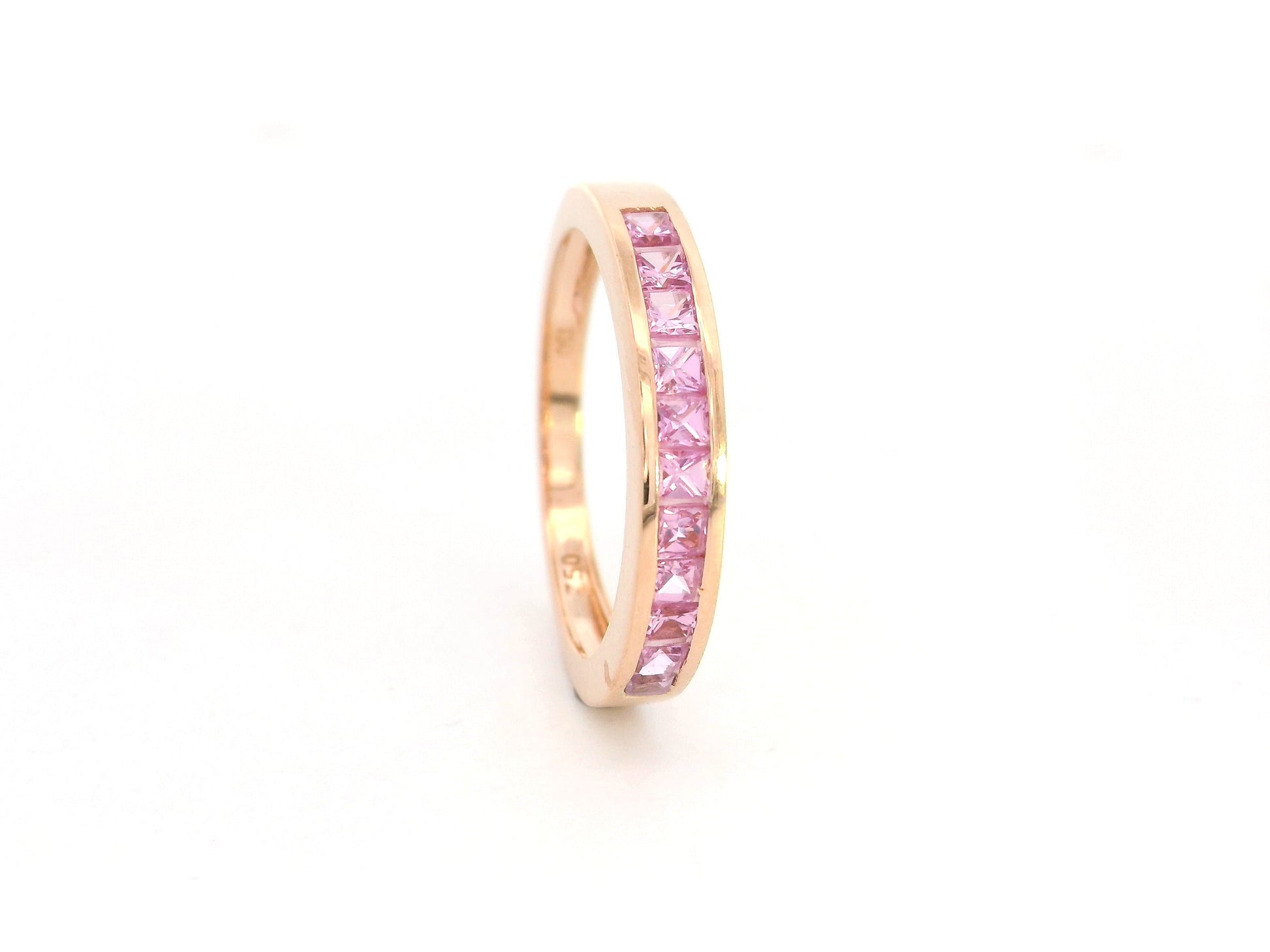 Pink sapphire channel set ring in 18K rose gold princess cut band