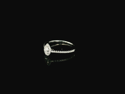 Natural pear shape diamond halo ring in solid 18K white gold featuring a pear-shaped centre diamond with a round brilliant diamond halo and pavé diamond band.
