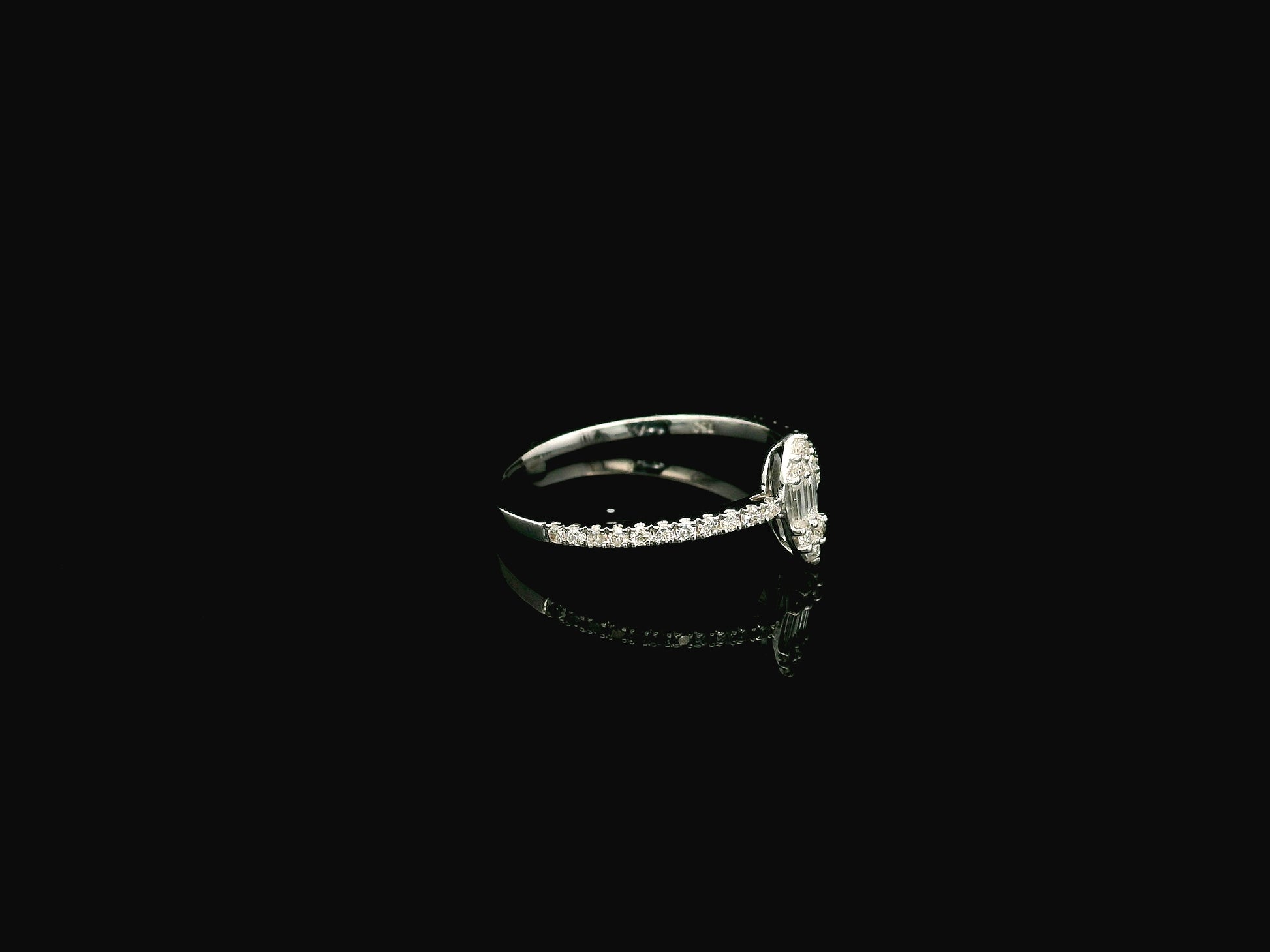 18K white gold marquise diamond ring featuring a combination of round brilliant and baguette diamonds with a total diamond weight of 0.28 carat.