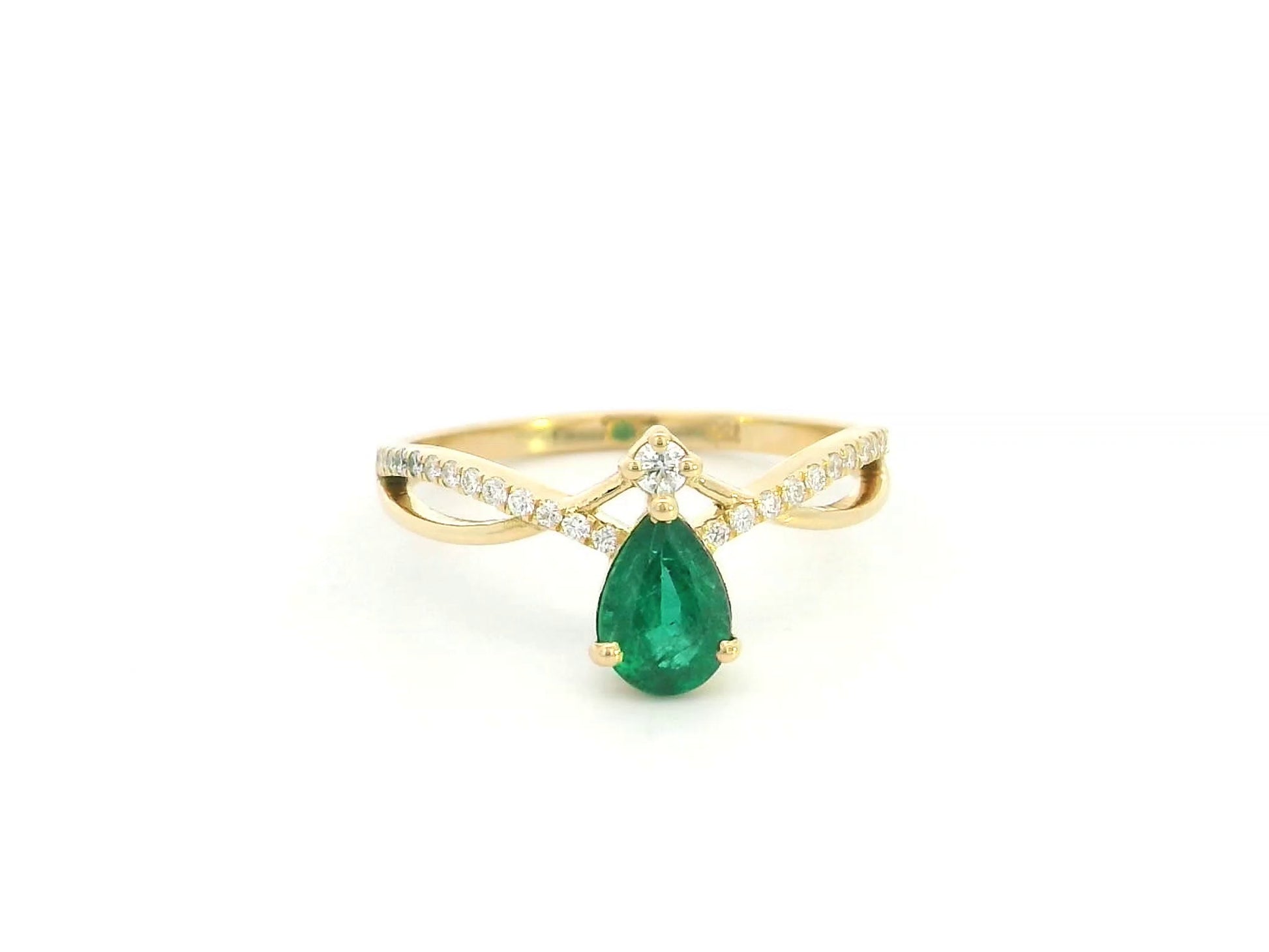 Pear shaped emerald and diamond crossover ring in 18K yellow gold