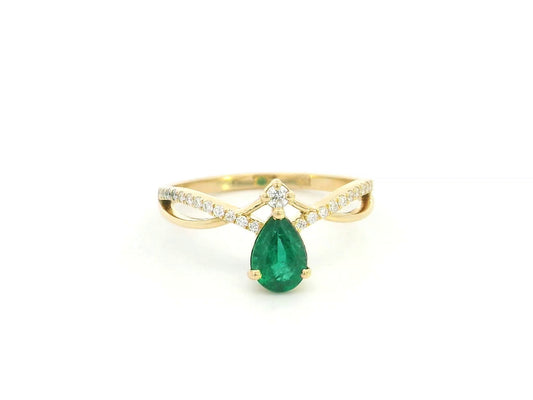 Pear shaped emerald and diamond crossover ring in 18K yellow gold