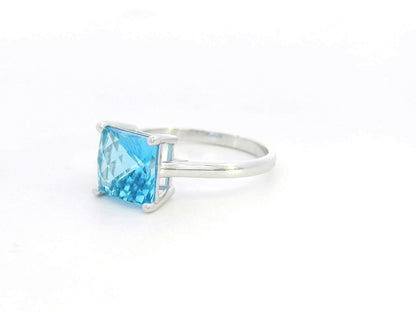 Square cut blue topaz solitaire ring in 18K white gold minimalist design