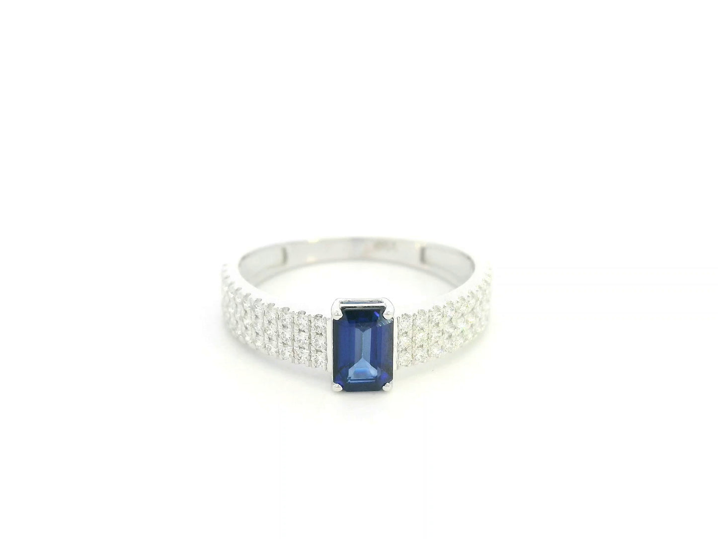 Emerald cut sapphire and diamond ring in 18K white gold