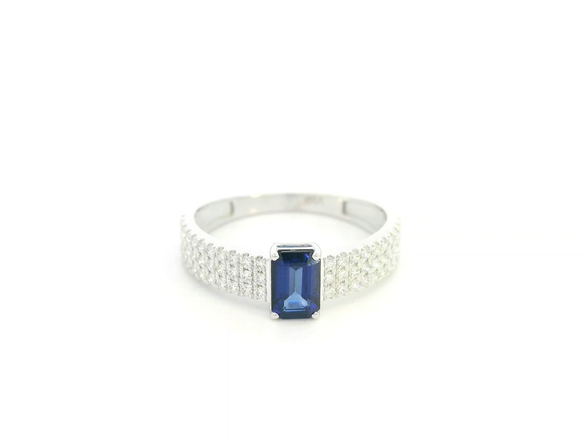 Emerald cut sapphire and diamond ring in 18K white gold