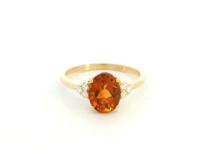 Oval citrine and diamond ring in 18K yellow gold with natural citrine center stone and diamond side accents