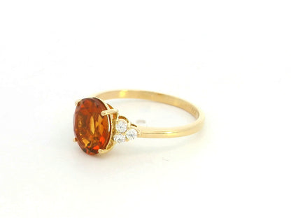Oval citrine and diamond ring in 18K yellow gold with natural citrine center stone and diamond side accents