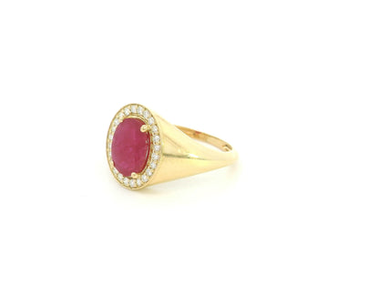 Men’s ruby and diamond ring in 18K yellow gold with oval ruby center stone and diamond halo