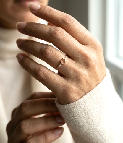 18K rose gold diamond heart ring with pavé-set diamonds and minimalist open heart design.