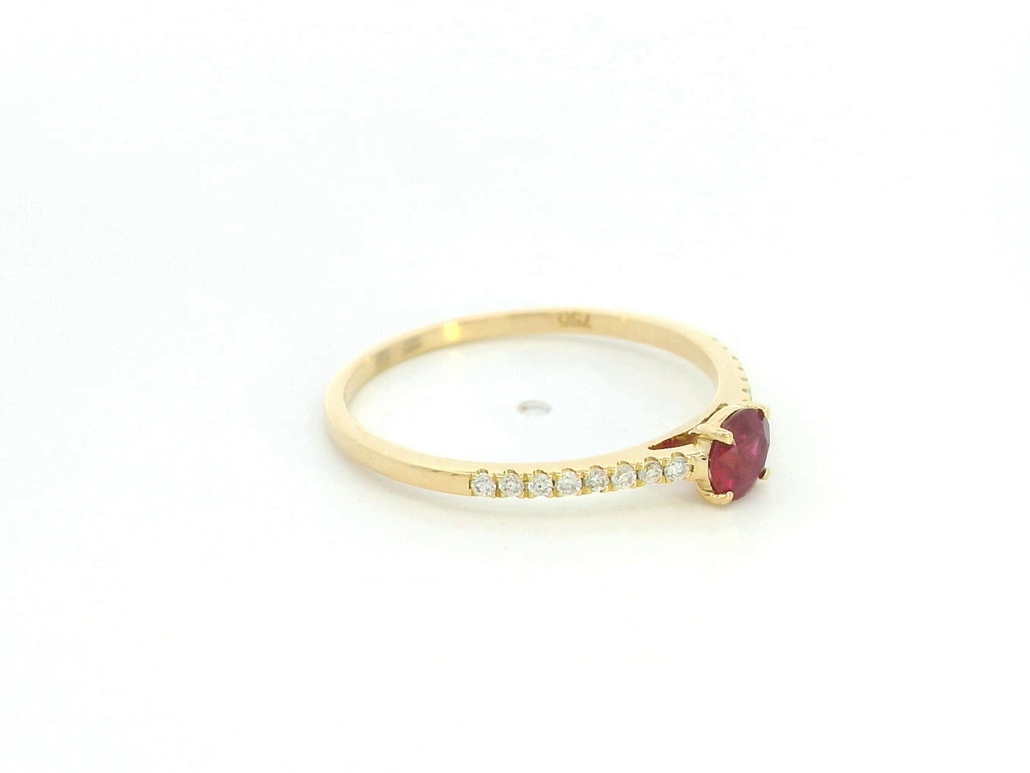Ruby and diamond solitaire ring in 18K yellow gold featuring a 0.36 carat natural ruby and 0.11 carat diamonds