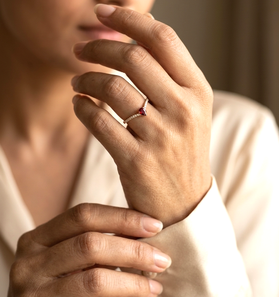 Ruby and diamond chevron ring in 18K yellow gold featuring a 0.19 carat pear-shaped ruby and 0.13 carat diamonds
