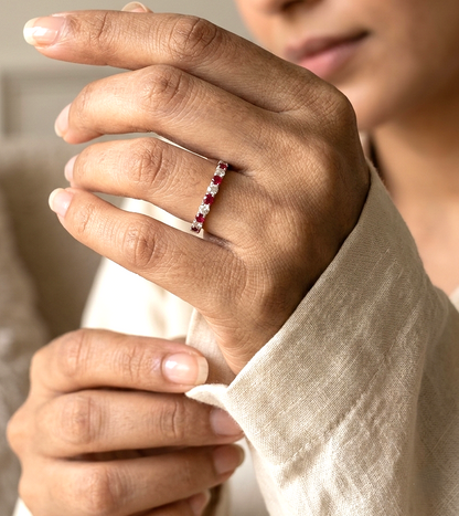 Ruby and diamond half eternity ring in 18K white gold with alternating round rubies and diamonds.