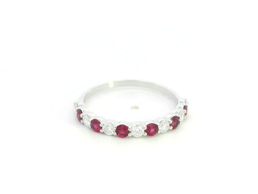 Ruby and diamond half eternity ring in 18K white gold with alternating round rubies and diamonds.