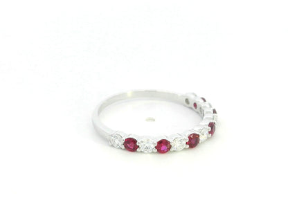 Ruby and diamond half eternity ring in 18K white gold with alternating round rubies and diamonds.