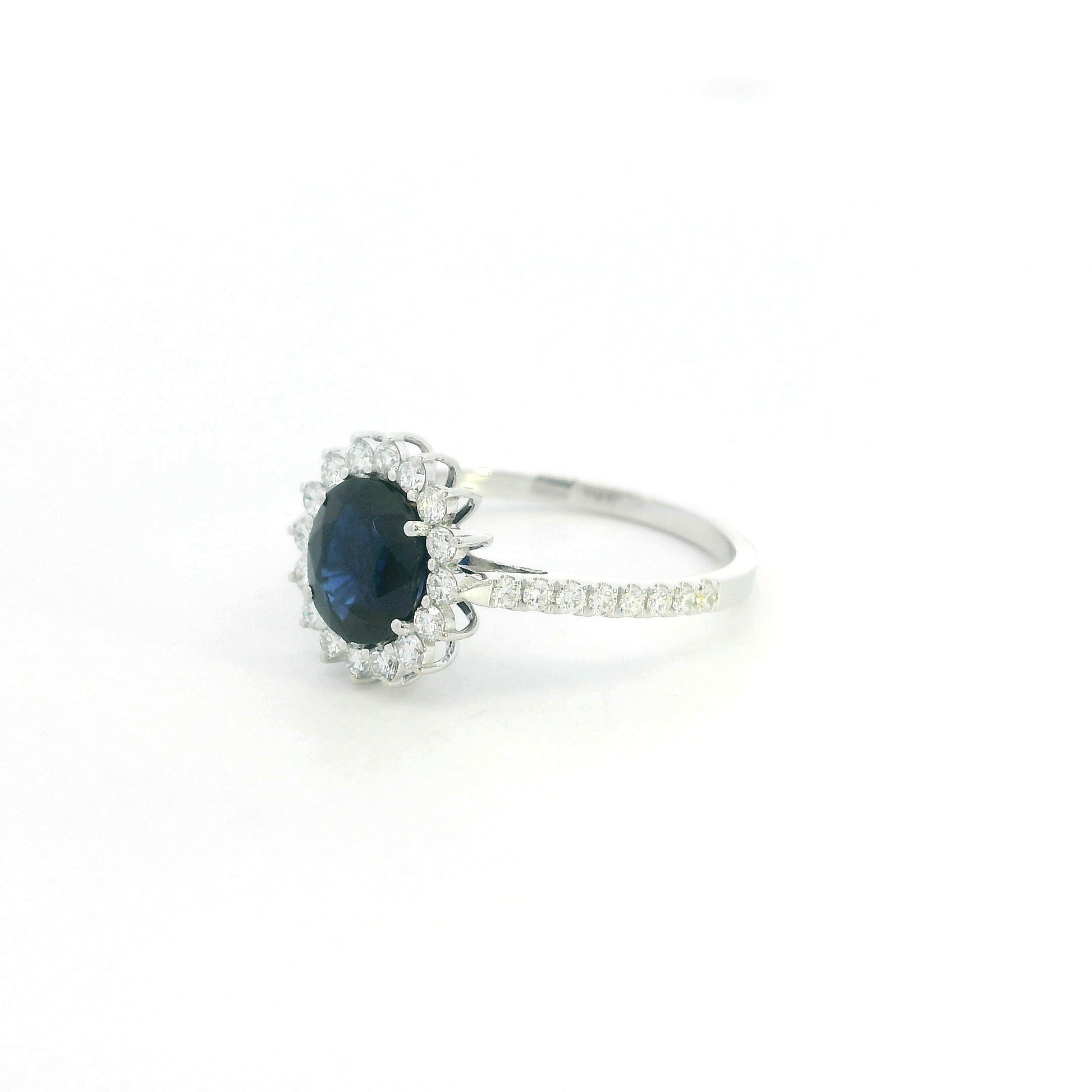 18K white gold blue sapphire and diamond halo ring with pavé diamond band