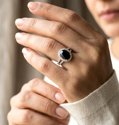 Oval blue sapphire halo ring in 18K white gold with diamond split shank band