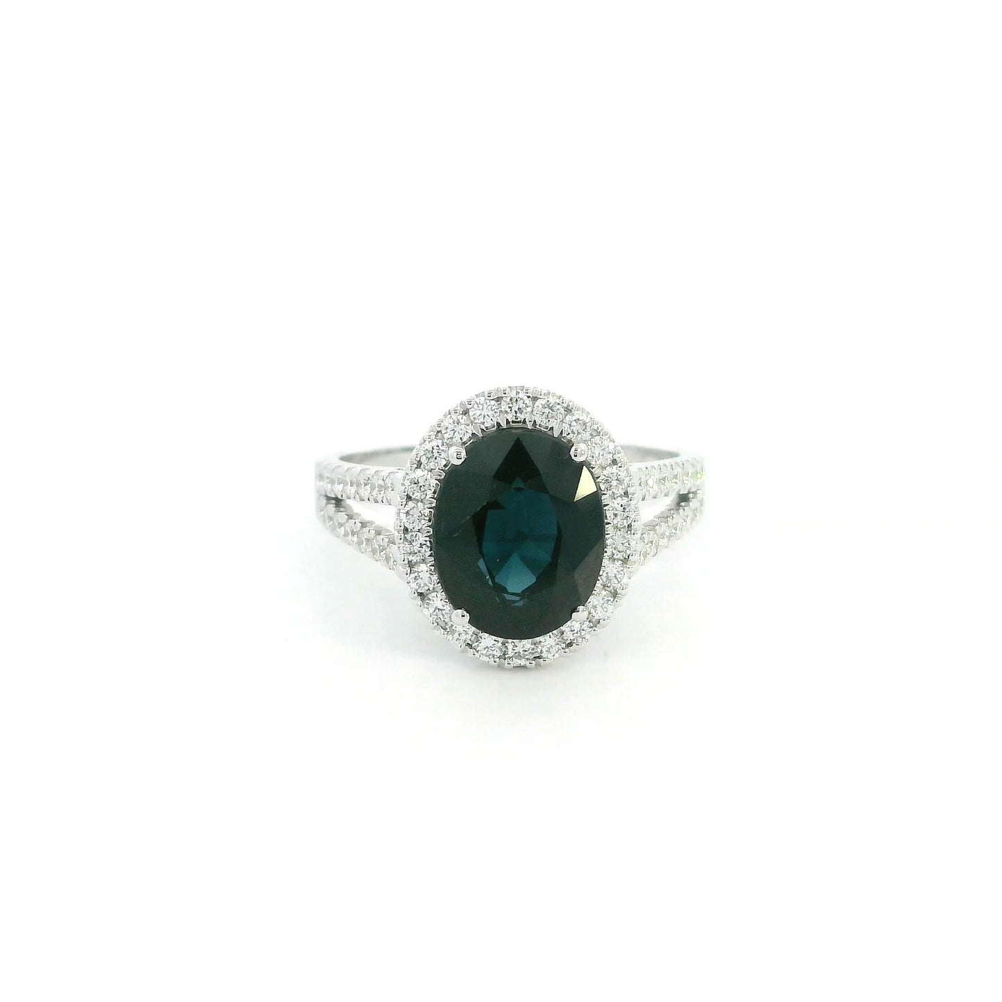 Oval blue sapphire halo ring in 18K white gold with diamond split shank band