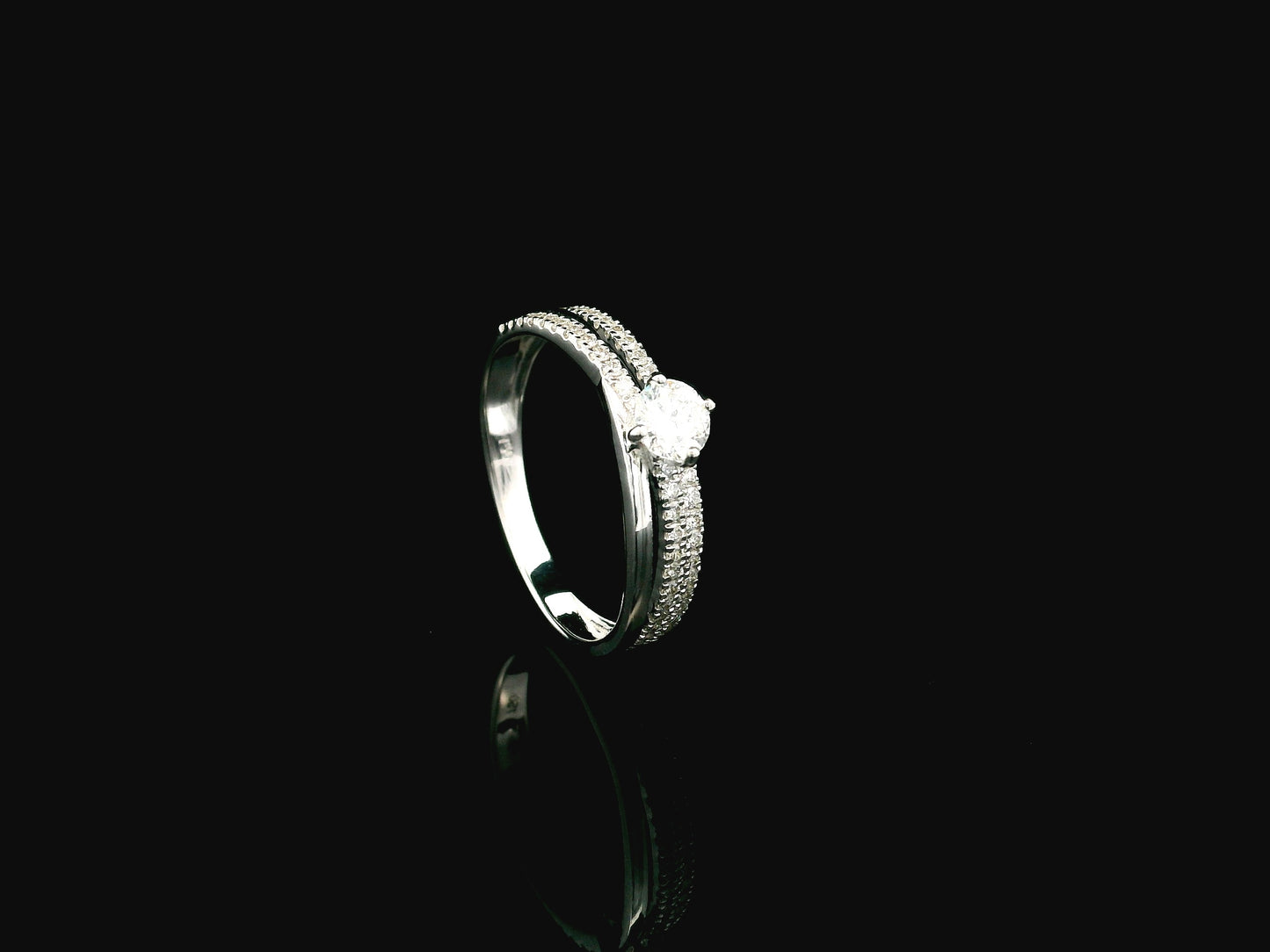 18K white gold diamond engagement ring featuring a 0.30 carat round center diamond and triple-row band with 0.28 carats of accent diamonds.