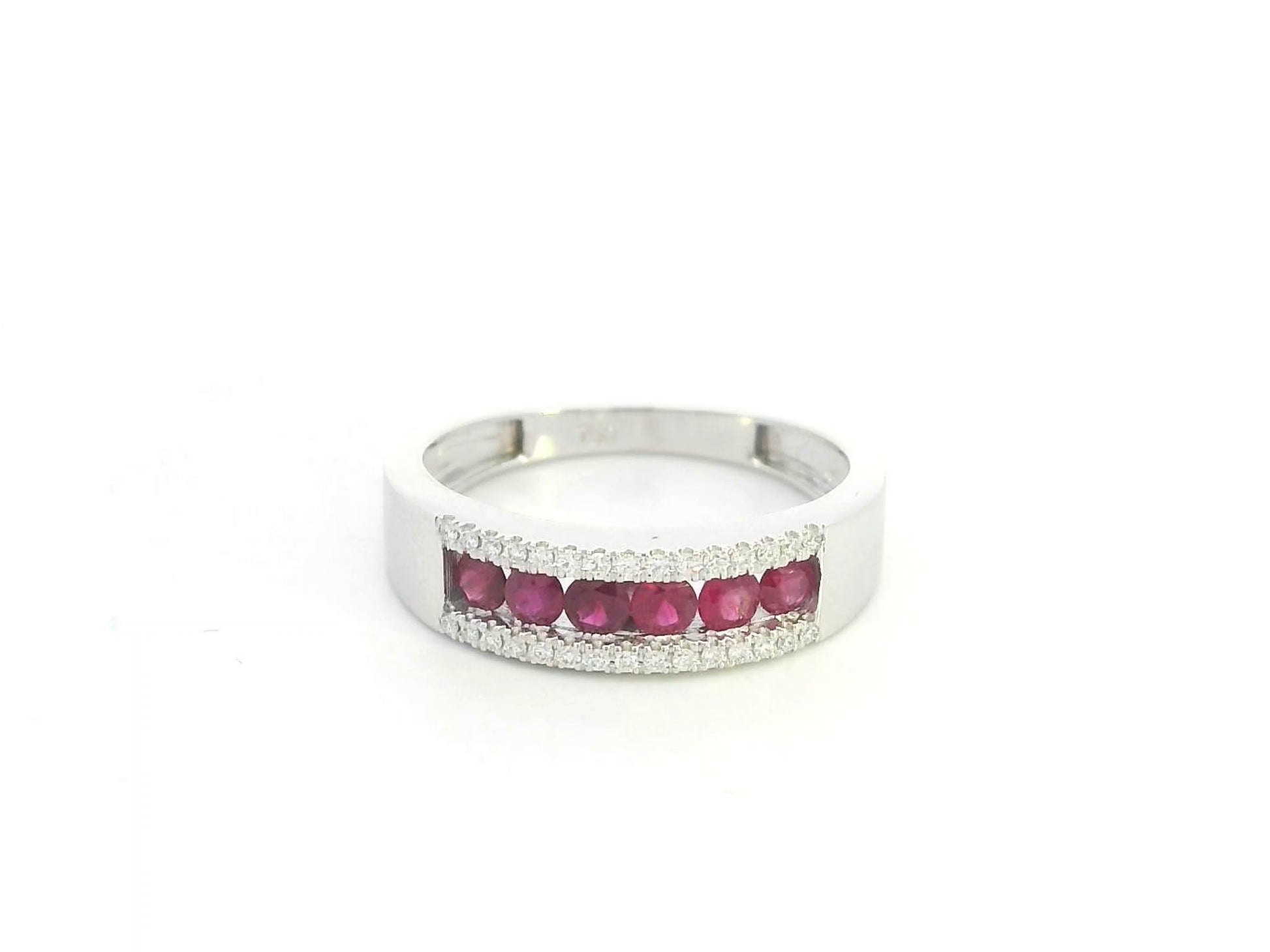 Ruby and diamond channel set ring in 18K white gold featuring 0.51 carat natural rubies and 0.12 carat diamonds