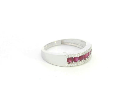 Ruby and diamond channel set ring in 18K white gold featuring 0.51 carat natural rubies and 0.12 carat diamonds