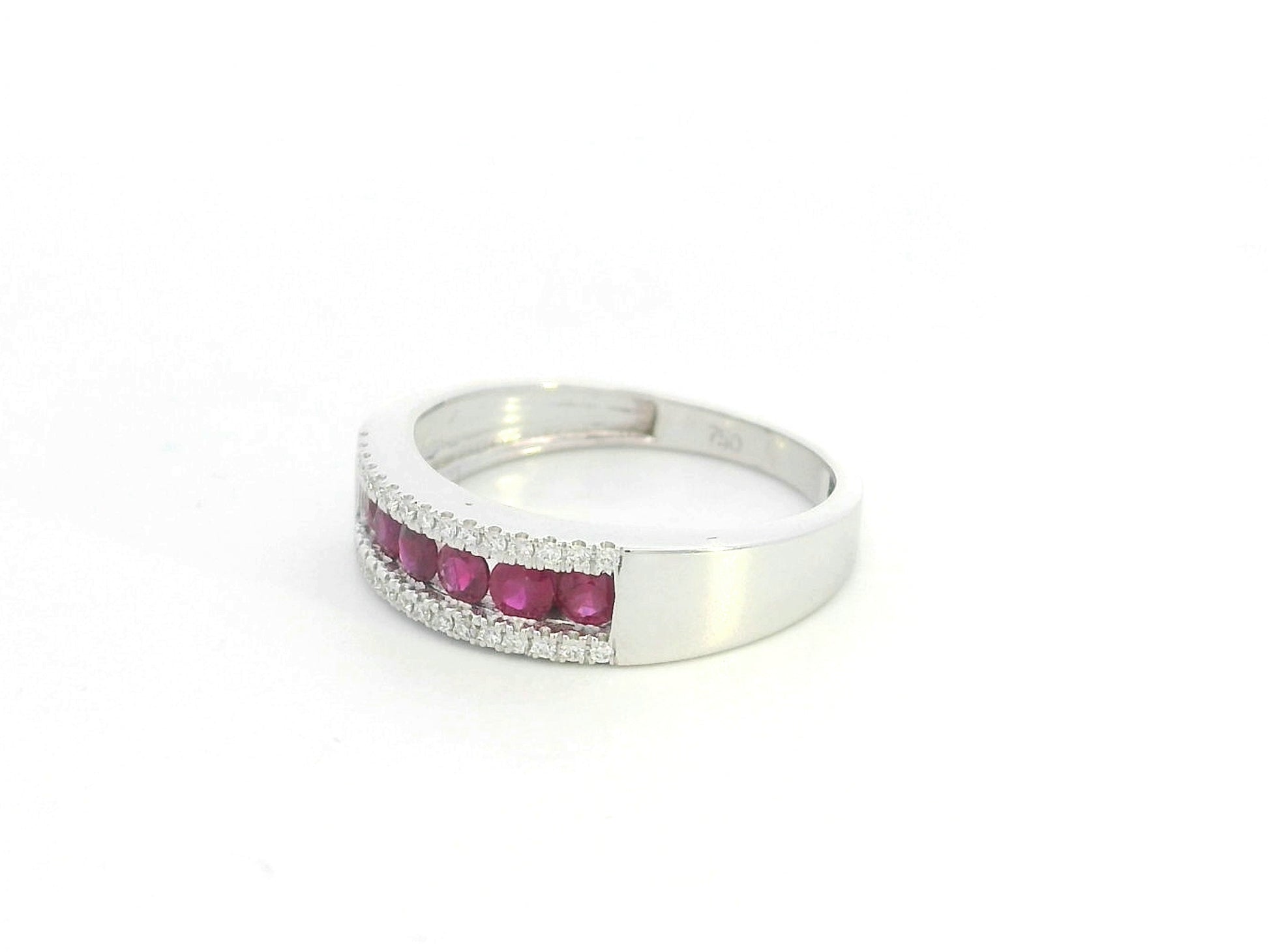 Ruby and diamond channel set ring in 18K white gold featuring 0.51 carat natural rubies and 0.12 carat diamonds