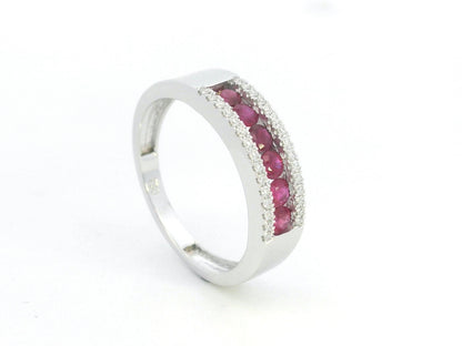 Ruby and diamond channel set ring in 18K white gold featuring 0.51 carat natural rubies and 0.12 carat diamonds