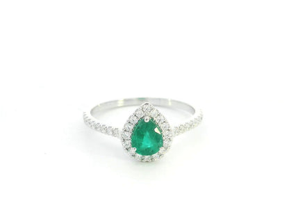 Pear shape emerald and diamond halo ring in 18K white gold by Emirates Diamonds
