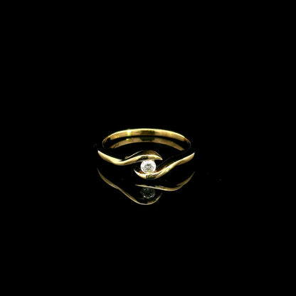 Solitaire diamond twist ring in 18K yellow gold featuring a 0.10 carat natural diamond