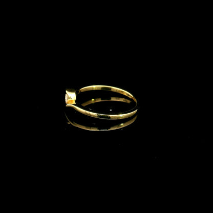 Solitaire diamond twist ring in 18K yellow gold featuring a 0.10 carat natural diamond